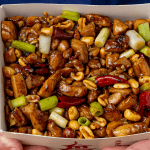 Chinese takeout kung pao chicken with peanuts and dried red chilis