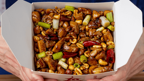Chinese takeout kung pao chicken with peanuts and dried red chilis