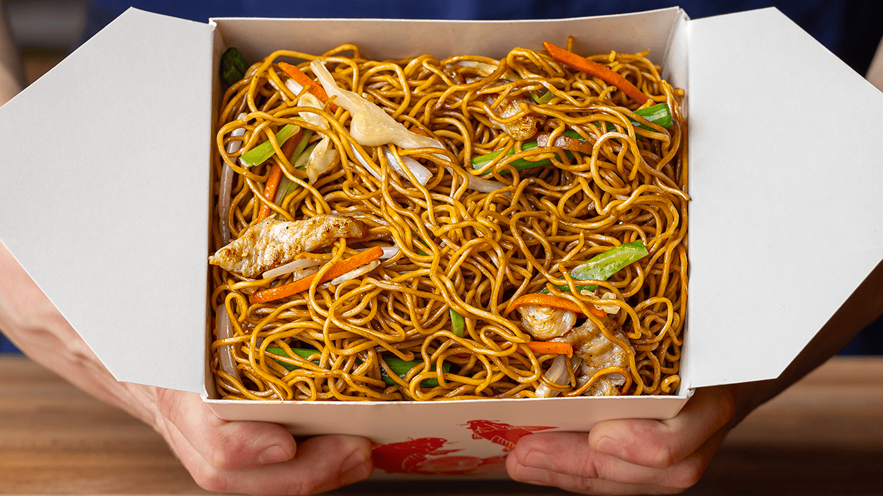 Chinese takeout chow mein with charred egg noodles and stir-fried chicken