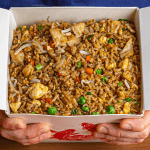 Chinese takeout fried rice with chicken, egg, and vegetables