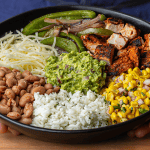 chipotle burrito bowl with adobo chicken cilantro lime rice pinto beans and guacamole
