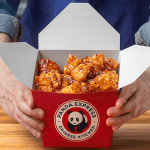 Homemade Panda Express orange chicken with crispy double-fried crust coated in tangy orange sauce served over white rice