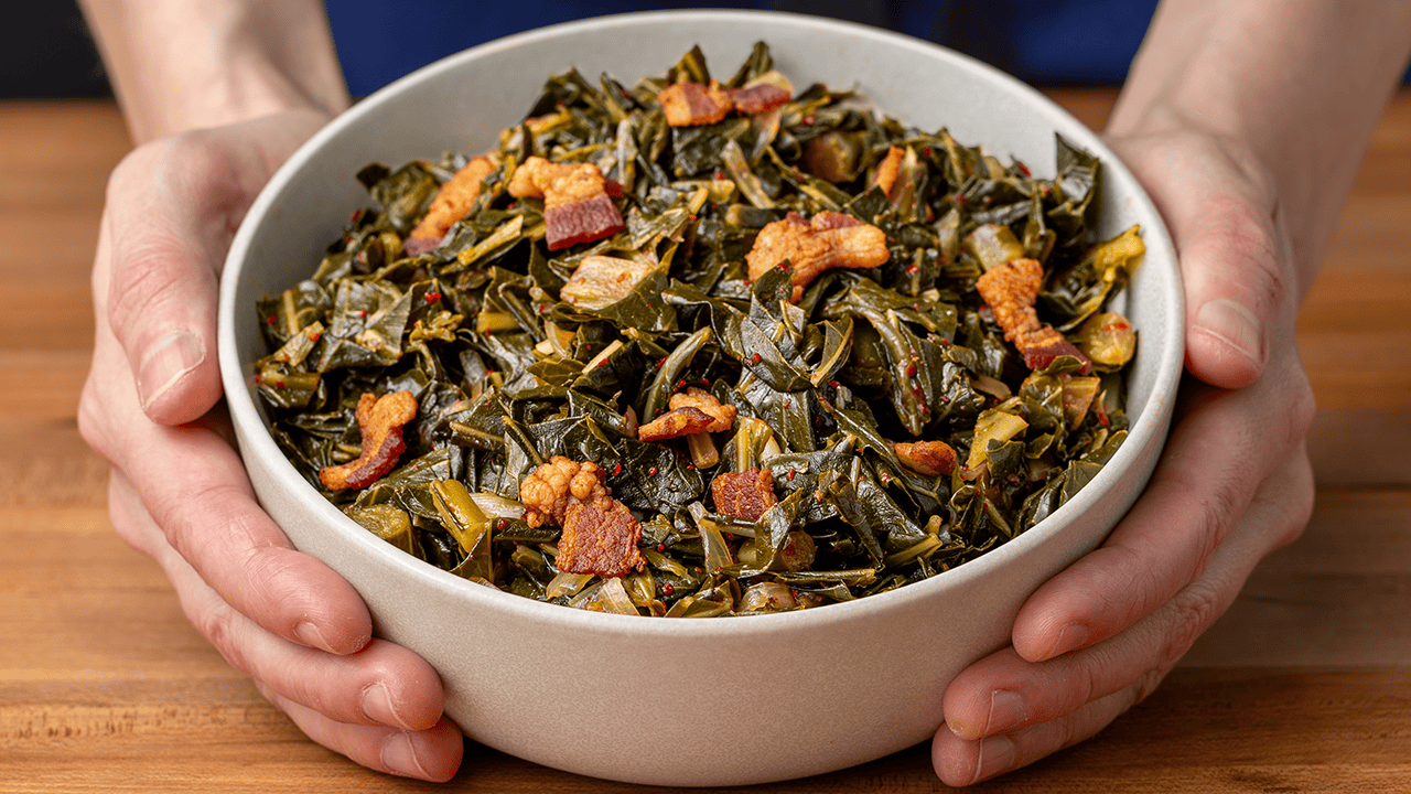Asian style collard greens with dashi broth and crispy bacon in a serving bowl