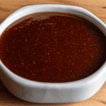 Benihana spicy teriyaki sauce in bowl with visible red pepper flecks