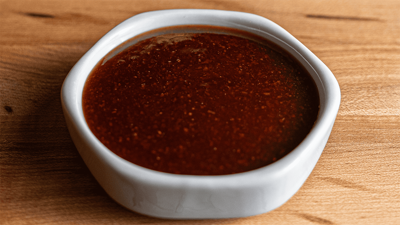 Benihana spicy teriyaki sauce in bowl with visible red pepper flecks