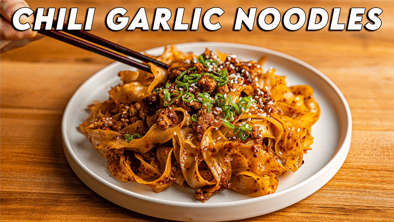 Chili garlic noodles with ground pork, sesame seeds, and green onions