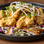 P.F. Chang's dynamite shrimp with crispy rice sticks on shredded cabbage