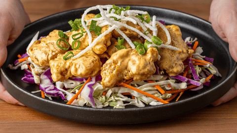 P.F. Chang's dynamite shrimp with crispy rice sticks on shredded cabbage