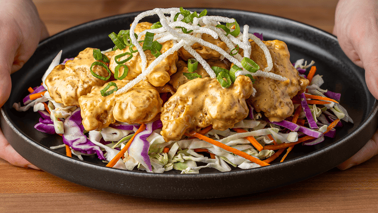P.F. Chang's dynamite shrimp with crispy rice sticks on shredded cabbage