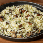 Gordon Ramsay mushroom risotto plated with sauteed mushrooms and chives