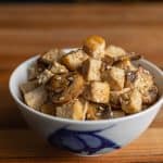 Hibachi chicken with mushrooms, sesame seeds, and garlic butter served on a plate