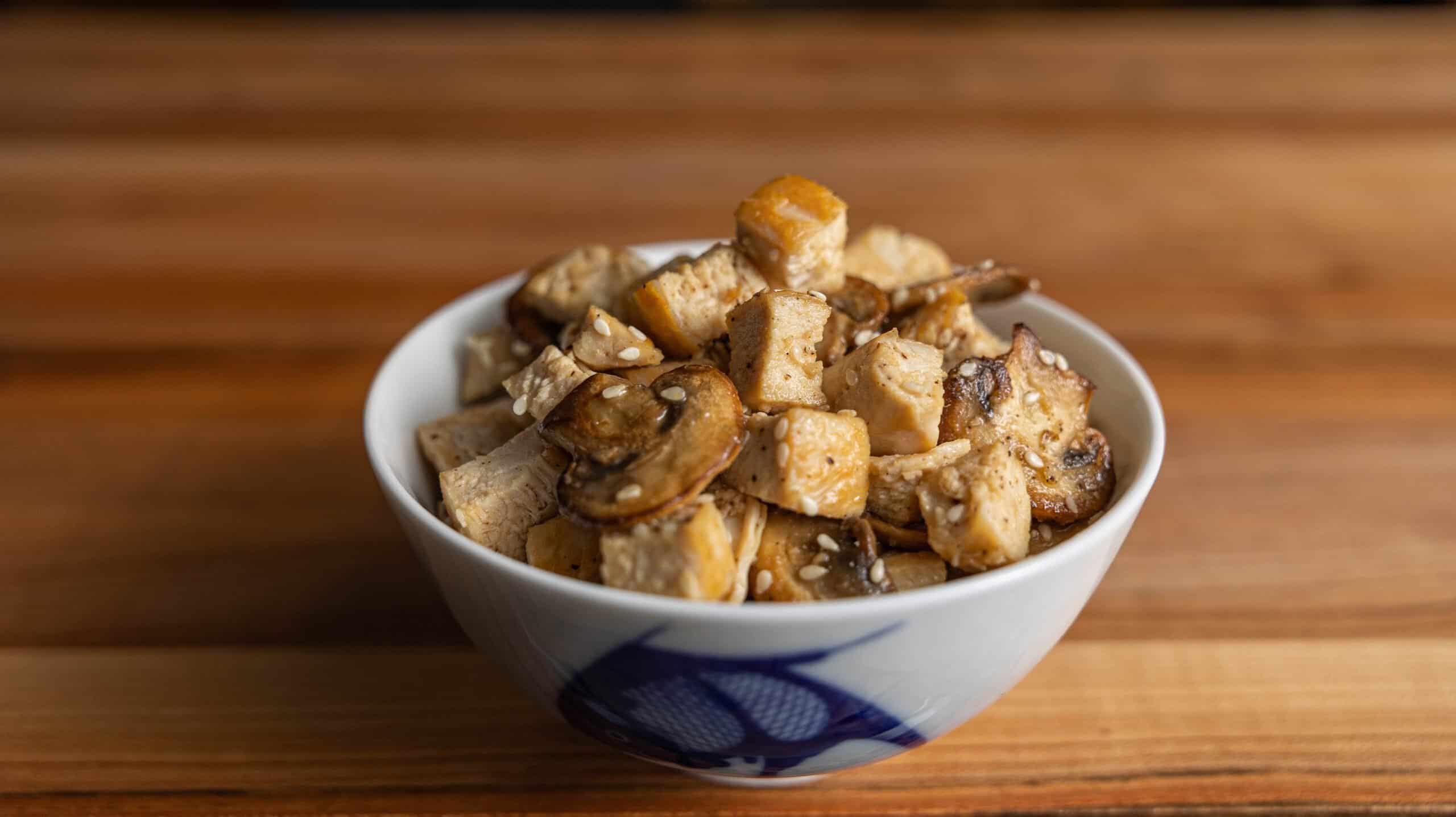 Hibachi chicken with mushrooms, sesame seeds, and garlic butter served on a plate