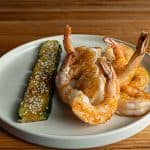 Hibachi shrimp with garlic butter and lemon served on a white plate