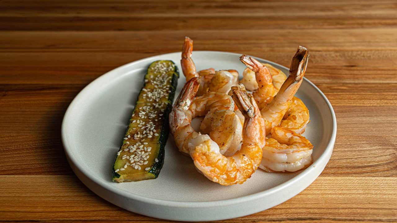 Hibachi shrimp with garlic butter and lemon served on a white plate