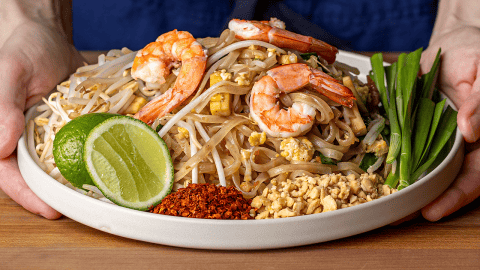 pad thai with shrimp garnished with lime peanuts and bean sprouts