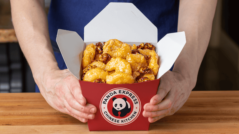 Panda Express honey walnut shrimp with glossy sauce and candied walnuts in a takeout box