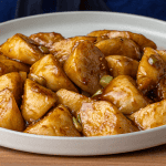 P.F. Chang's stir-fried eggplant with glossy sauce on a plate