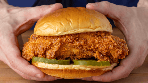 Popeyes fried chicken sandwich on a toasted brioche bun with pickles and mayo