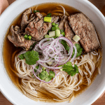 World-class beef pho with rare beef, brisket, herbs, and golden broth