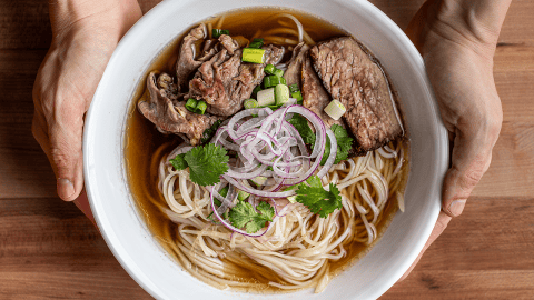 World-class beef pho with rare beef, brisket, herbs, and golden broth
