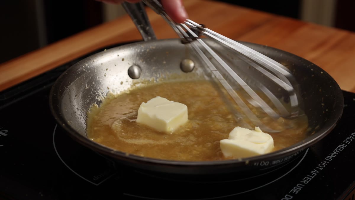 Whisking pieces of butter into the miso sauce with the heat off